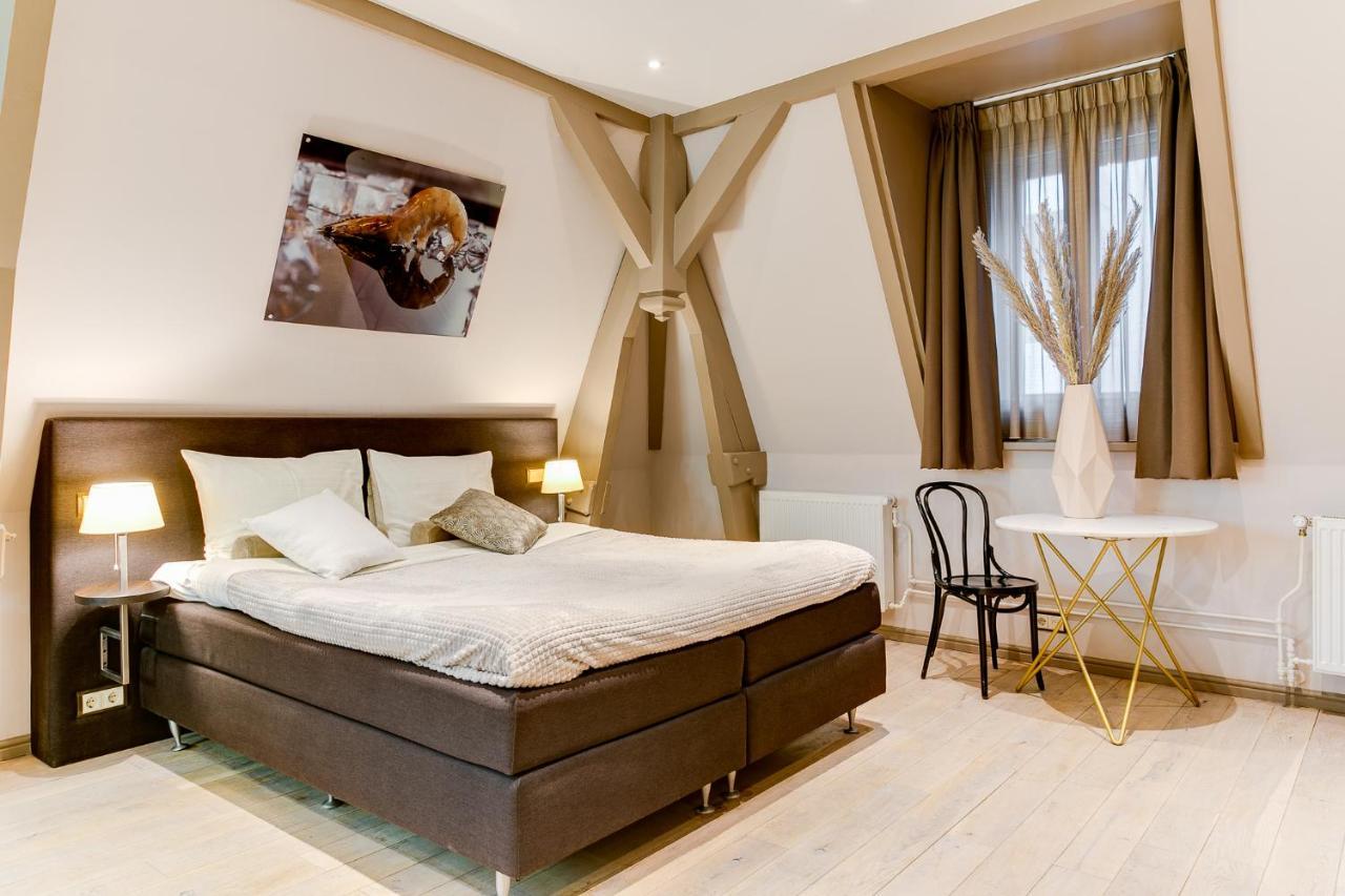 Brasss Hotel Suites Haarlem Esterno foto A room at the hotel